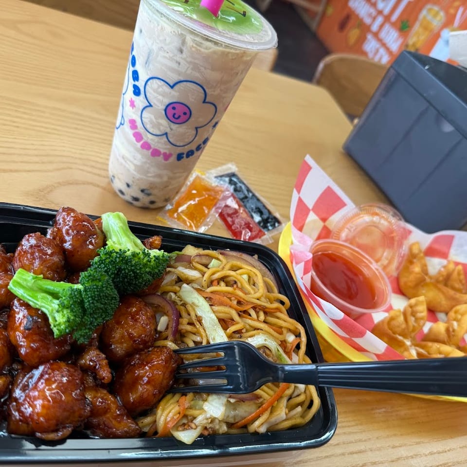 Orange chicken with broccoli, lo mein, crab rangoons, sweet and sour sauce, and boba tea.